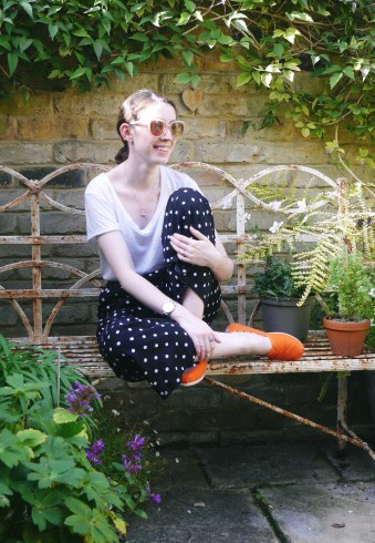 Blogger laughing on a bench